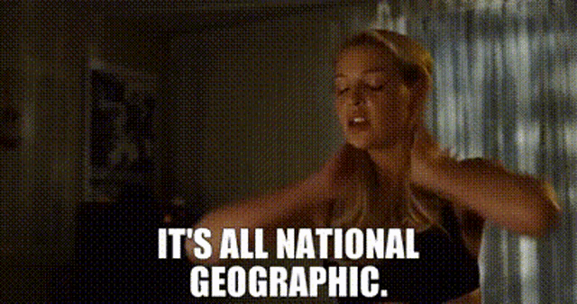 a woman is standing in front of a window and saying it 's all national geographic .
