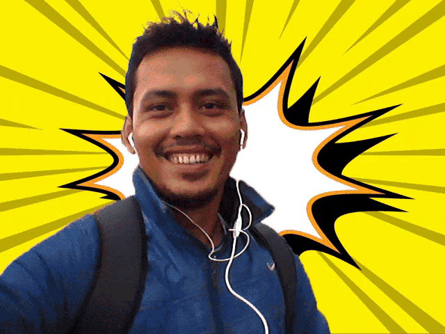 a man wearing ear buds and a blue jacket smiles in front of a comic book background