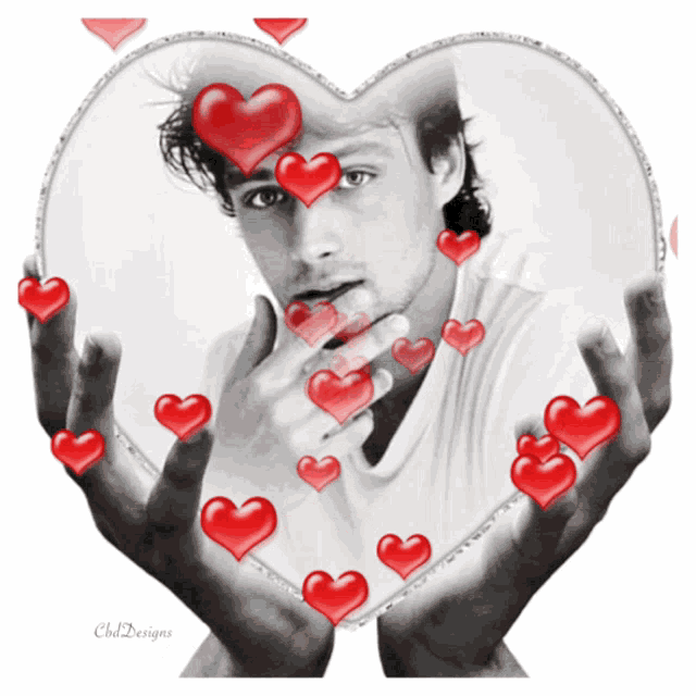 a black and white photo of a man with red hearts around his face