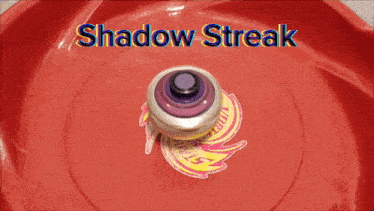 a shadow streak spinning top is on a red surface