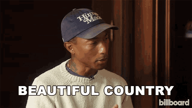 a man wearing a hat and sweater says " beautiful country "