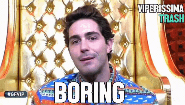 a man sitting in a chair with the word boring written on his face