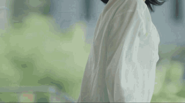a woman wearing a white shirt is smiling for the camera