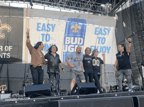 a group of people on a stage in front of a bud light banner