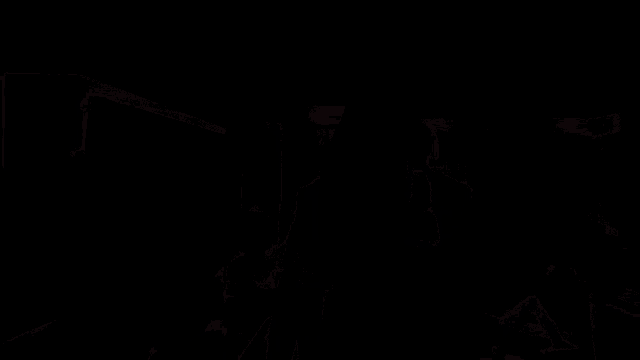 a person with a mask on their face is standing in a dark room