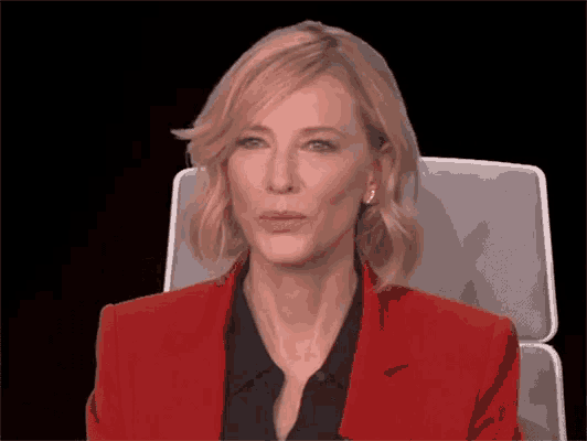 a woman wearing a red jacket and black shirt