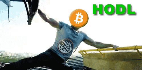 a man wearing a viral chop shirt is jumping over a wall with a bitcoin head
