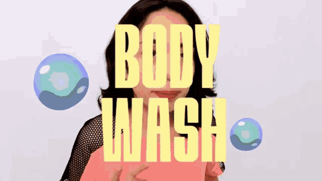 a woman in a pink shirt is standing in front of the words body wash