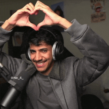 a man wearing headphones makes a heart with his hands