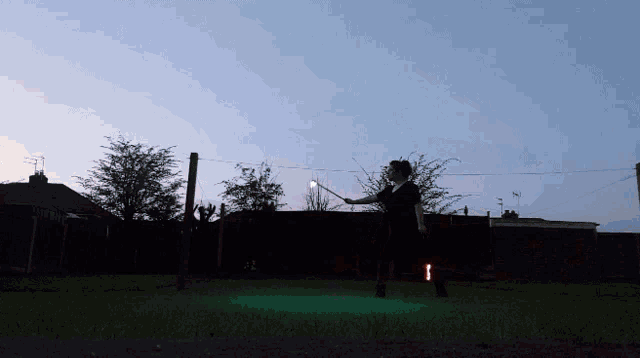 a person in a black shirt is holding a green light
