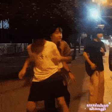 a group of people are dancing on a sidewalk with the words suxinhao zhangi on the bottom
