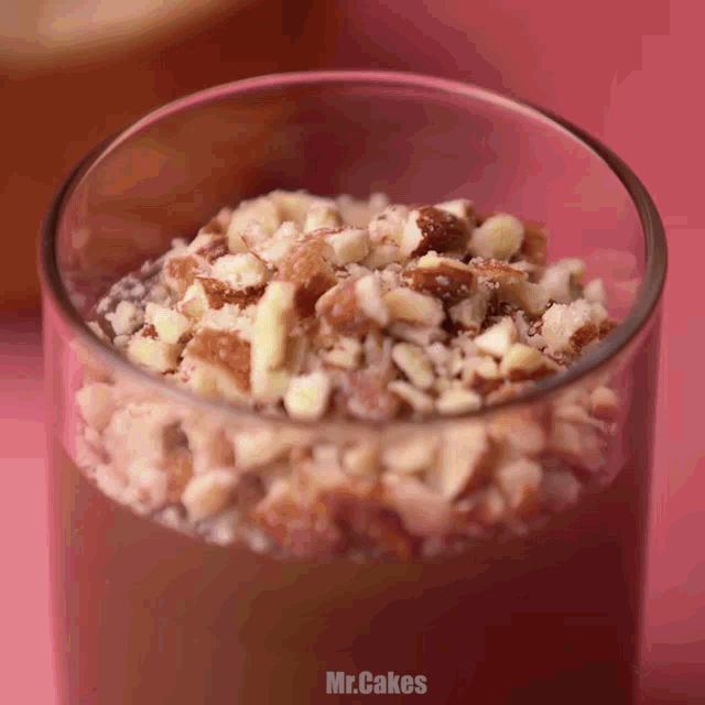 a close up of a glass filled with nuts and the words mr.cakes below it