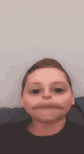 a child is making a funny face with his mouth wide open