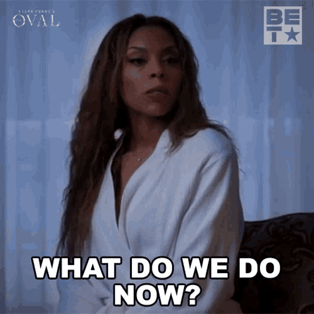 a woman sitting on a couch with the words what do we do now below her