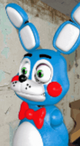 a blue stuffed bunny with a red bow tie on its neck