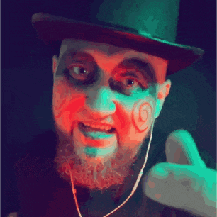 a man in a top hat has a swirl painted on his face and a beard