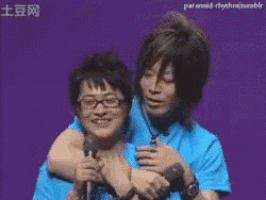 two men are hugging each other in front of a purple background