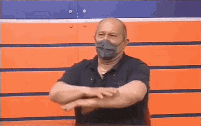 a man wearing a mask is making a funny face .