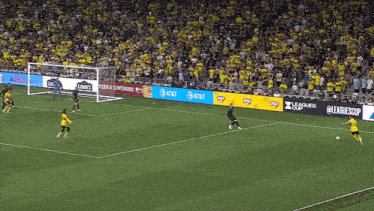 a soccer game is being played on a field with advertisements for at & t lays and lowe 's