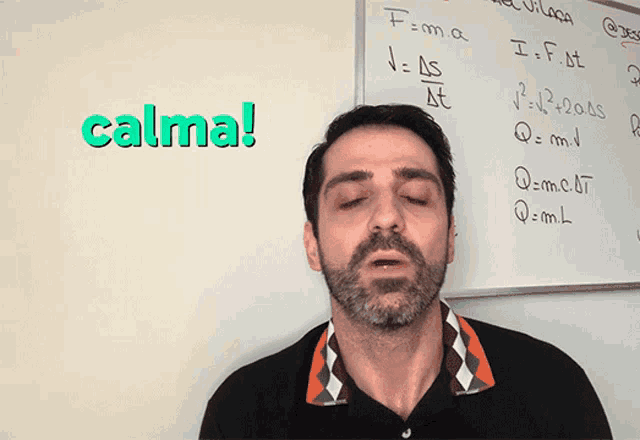 a man stands in front of a white board with the word calma written on it