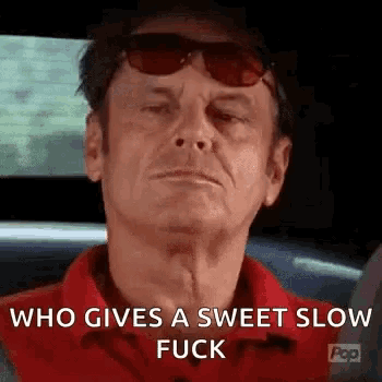 a man wearing sunglasses and a red shirt is sitting in a car and says `` who gives a sweet slow fuck '' .