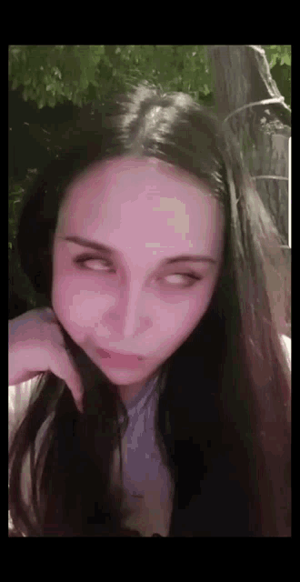 a close up of a woman making a funny face with her eyes closed