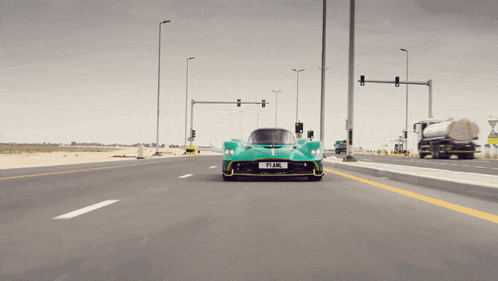 a green sports car with a license plate that says fiaml