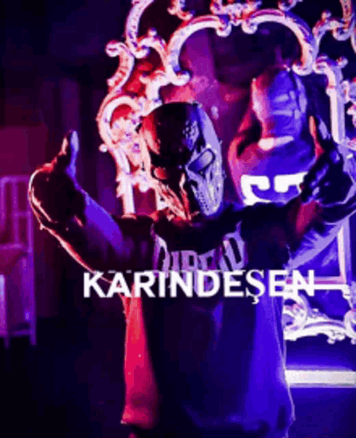 a man in a mask is giving a thumbs up in front of a throne with the word karindesen on it