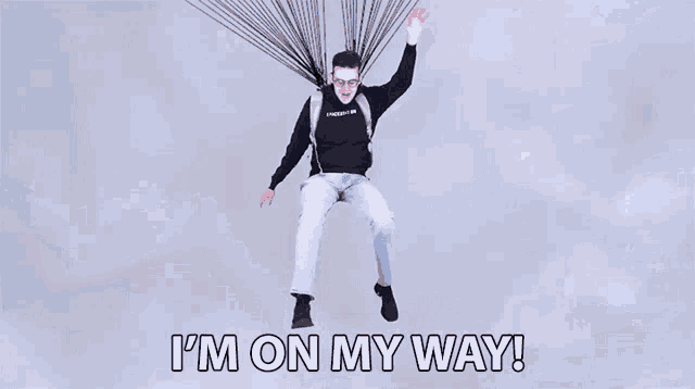 a man is flying through the air with the words " i 'm on my way " written below him
