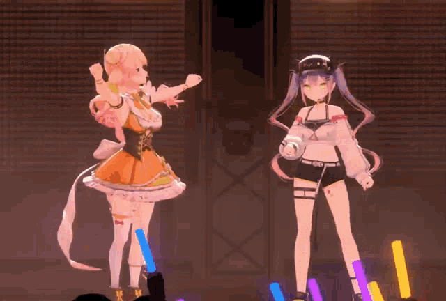 two anime girls are dancing on a stage