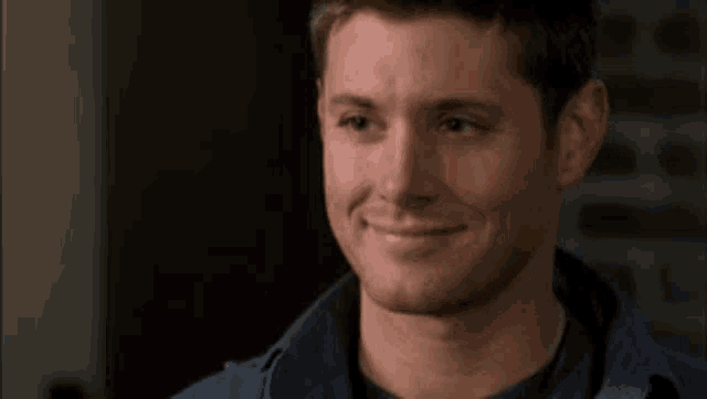 a close up of a man 's face with a smile on it .