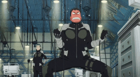 a man in a black suit with a red face is standing in a room