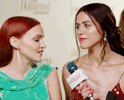 two women are being interviewed by a person with a hollywood microphone