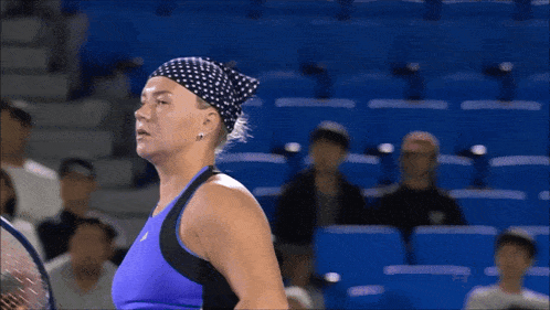 a tennis player wearing a headband and holding a tennis racket