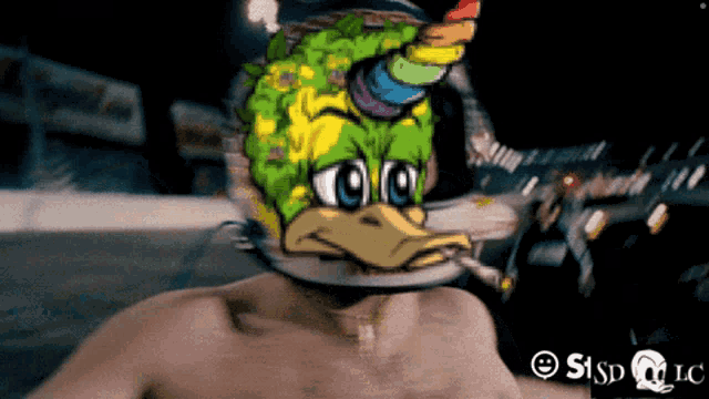 a shirtless man is wearing a duck mask with a rainbow horn