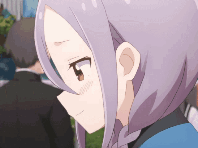 a close up of a girl 's face with purple hair and brown eyes