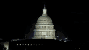a blurry picture of the white house at night with a washington news bar