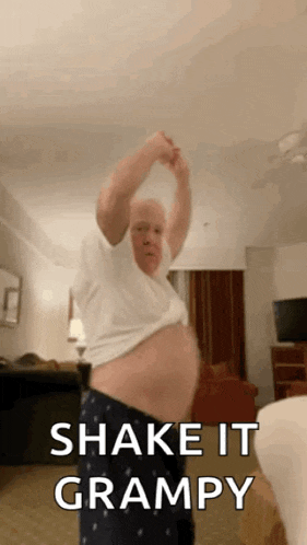 an older man is dancing in a room with the words `` shake it grampy '' written on the screen .