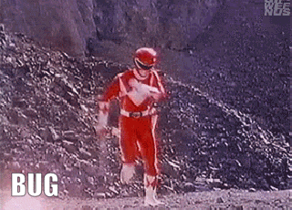 a red power ranger is walking down a dirt road with the word bug written on the ground .