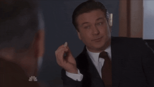 a man in a suit and tie is holding a piece of paper in his hand