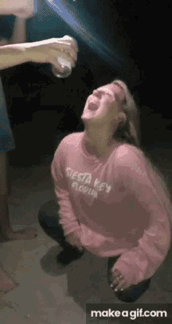 a woman wearing a pink sweater that says fiesta key florida on it