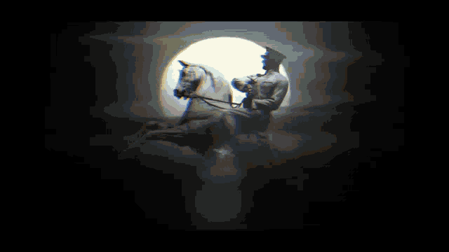 a statue of a man riding a horse in front of the moon