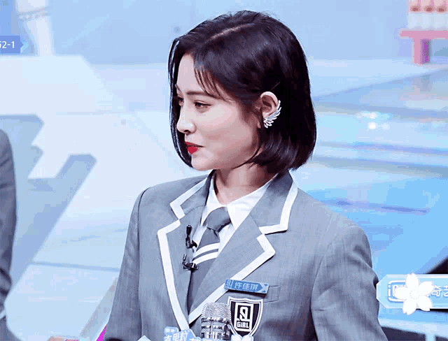 a woman in a suit has a name tag that says girl on it