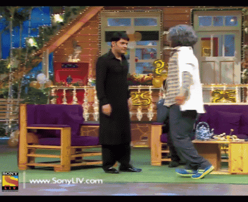 two men are dancing in front of a sign that says sony live