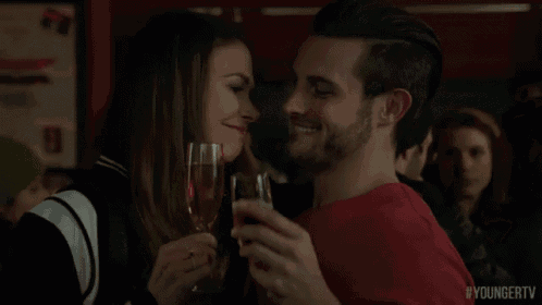 a man and a woman are toasting with champagne glasses and the hashtag youngertv is visible in the corner
