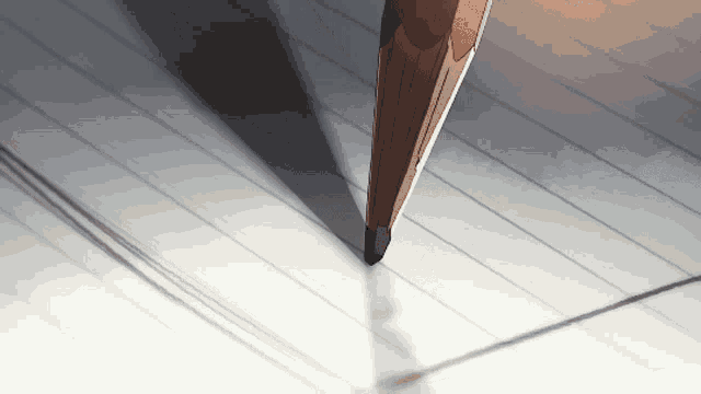 a pencil is writing on a piece of lined paper