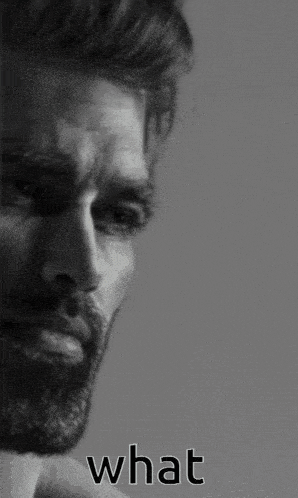 a black and white photo of a man with a beard and the word what written below him