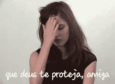 a woman is covering her face with her hand and the words `` que deus te proteja , amiga '' are written above her .
