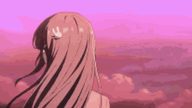a girl with long hair is looking at the sky .