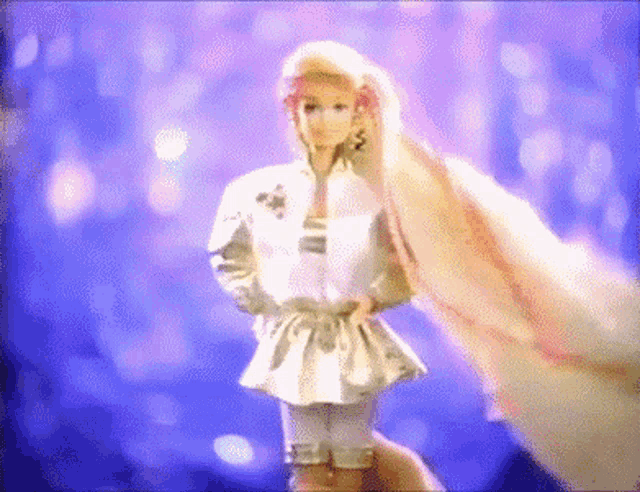 a barbie doll is being held in someone 's hand with a purple background